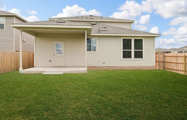 back of house featuring a patio and a shingled roof