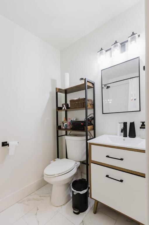 909 Reinli St Unit 102, Austin, TX 78751 - full bath featuring vanity, marble look tile flooring, and a shower with shower curtain