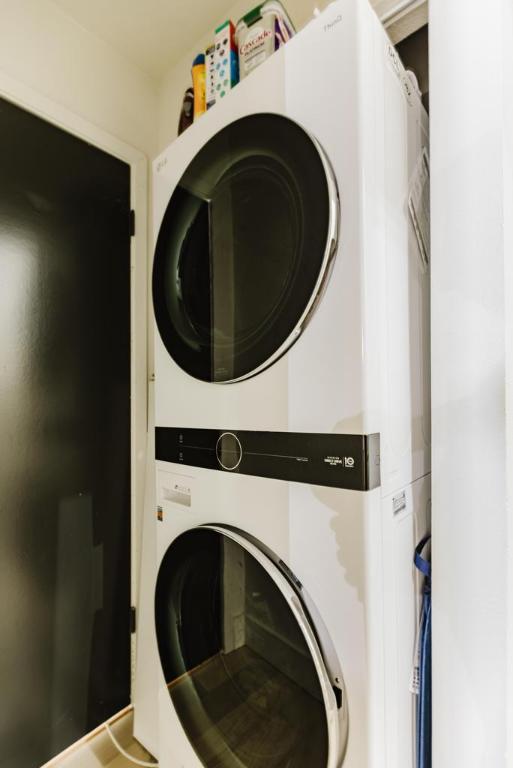 909 Reinli St Unit 102, Austin, TX 78751 - washroom featuring estacked washer and dryer