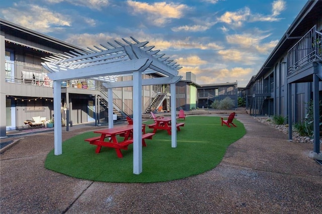 909 Reinli St Unit 102, Austin, TX 78751 - view of playground featuring a pergola and stairway