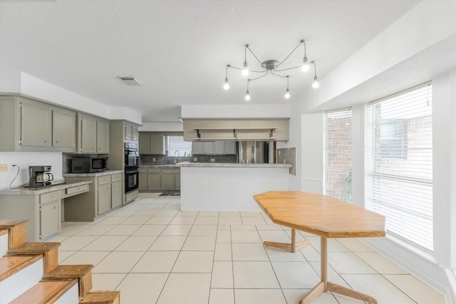 5519 Coon Tree Ct, Humble, TX 77346 - kitchen featuring stainless steel microwave, gray cabinets, backsplash, light countertops, and a sink