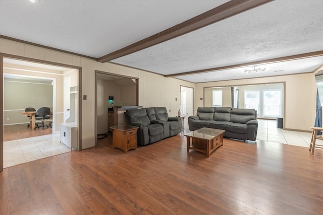5519 Coon Tree Ct, Humble, TX 77346 - living room featuring wood finished floors, a textured ceiling, and beamed ceiling