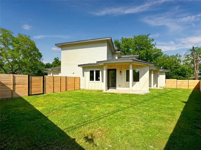 3614 Abbate Cir Unit B, Austin, TX 78721 - rear view of property featuring board and batten siding and a patio