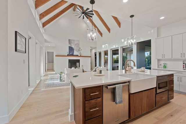1769 Parten Ranch Pkwy, Austin, TX 78737 - kitchen featuring a sink, high vaulted ceiling, beam ceiling, stainless steel appliances, and light countertops