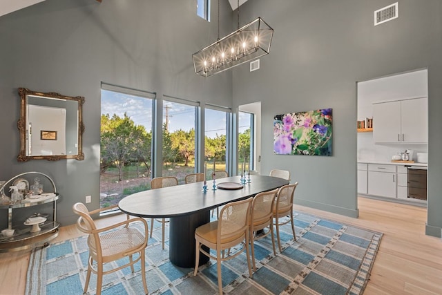1769 Parten Ranch Pkwy, Austin, TX 78737 - dining area featuring a towering ceiling, light wood-style floors, and a chandelier