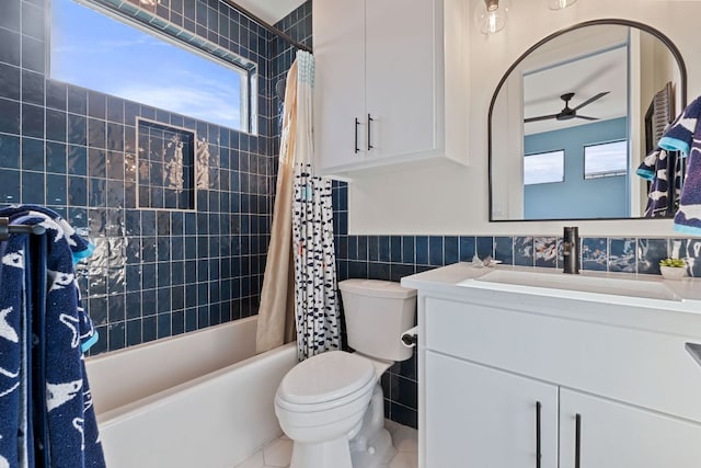 1769 Parten Ranch Pkwy, Austin, TX 78737 - full bathroom featuring tile walls, a ceiling fan, shower / bathtub combination with curtain, vanity, and a wainscoted wall