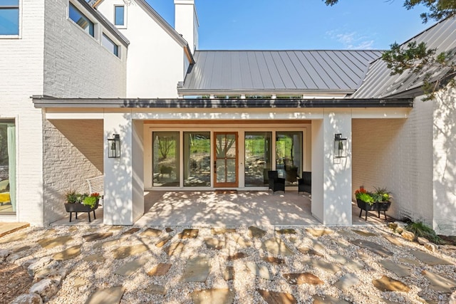 1769 Parten Ranch Pkwy, Austin, TX 78737 - doorway to property with brick siding, french doors, a patio area, and metal roof