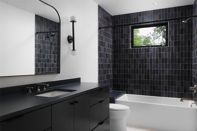bathroom featuring  shower combination, vanity, toilet, and tile patterned floors