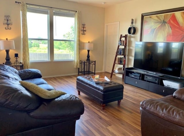 living room featuring wood finished floors and baseboards