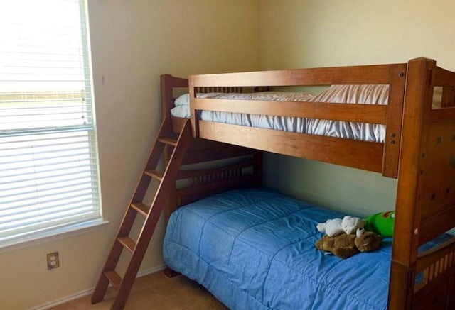 bedroom with multiple windows, carpet floors, and baseboards