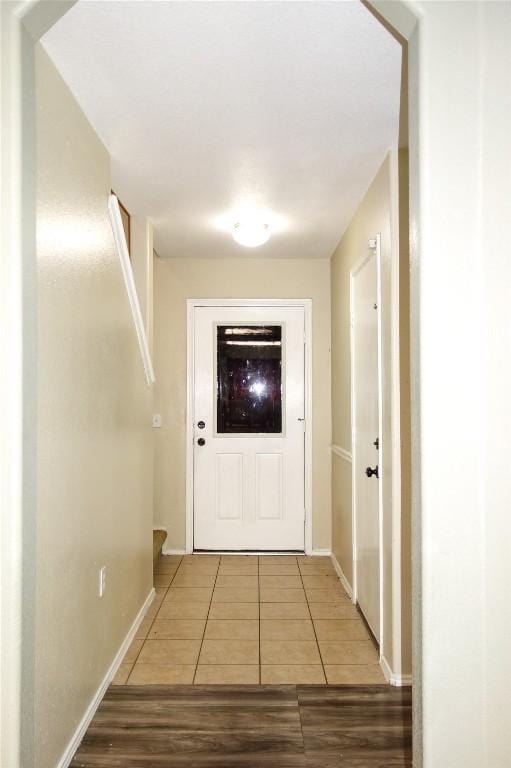 12301 Paloma Blanca Way, Del Valle, TX 78617 - doorway to outside featuring tile patterned flooring and baseboards