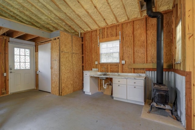 203 Hickory Dr, Sheridan, TX 77475 - misc room with a wood stove and concrete flooring