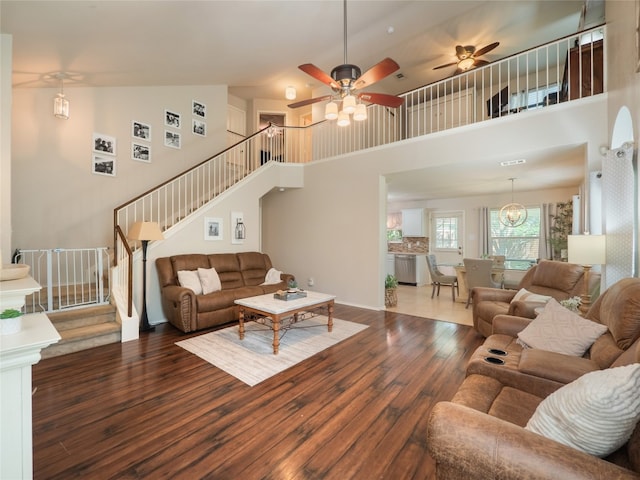 107 Wisteria Way, San Marcos, TX 78666 - living area with wood-type flooring, stairway, a high ceiling, and ceiling fan