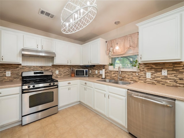 107 Wisteria Way, San Marcos, TX 78666 - kitchen featuring stainless steel appliances, a sink, under cabinet range hood, white cabinetry, and light countertops