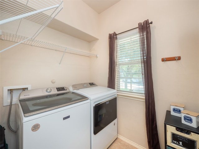 107 Wisteria Way, San Marcos, TX 78666 - washroom featuring washing machine and dryer, baseboards, and light tile patterned floors