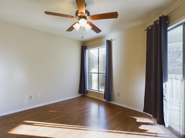 2450 Wickersham Ln Unit 702, Austin, TX 78741 - unfurnished room with wood finished floors, ceiling fan, and baseboards