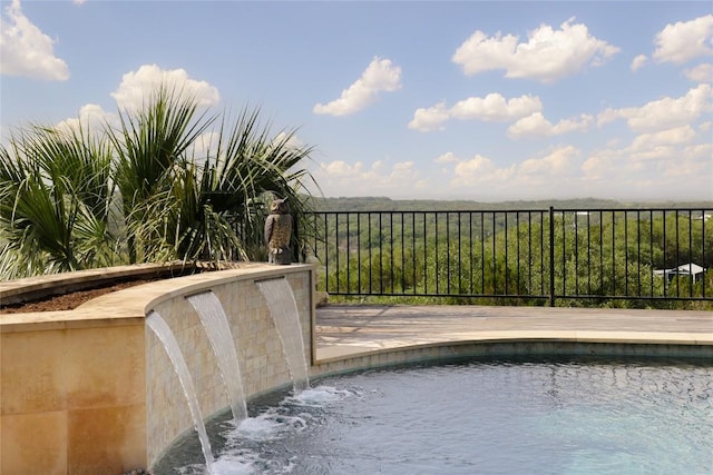 view of swimming pool with fence