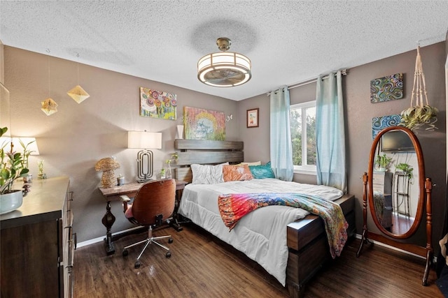 1402 Dove Hill Dr, Cedar Park, TX 78613 - bedroom featuring dark wood-type flooring, a textured ceiling, and baseboards