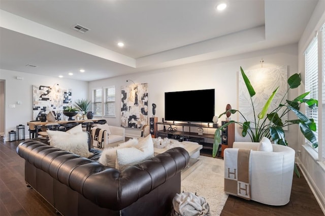 living room featuring dark wood-style floors, recessed lighting, baseboards, and a raised ceiling