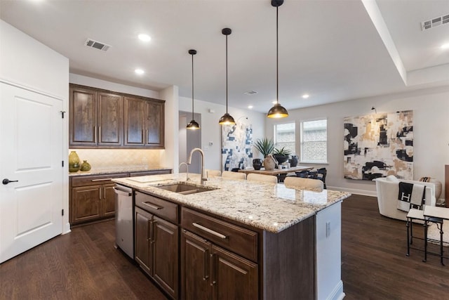 kitchen with a sink, open floor plan, dark wood-style flooring, decorative backsplash, and dishwasher