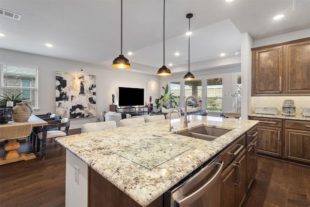 kitchen featuring a sink, dishwasher, dark wood finished floors, healthy amount of natural light, and recessed lighting