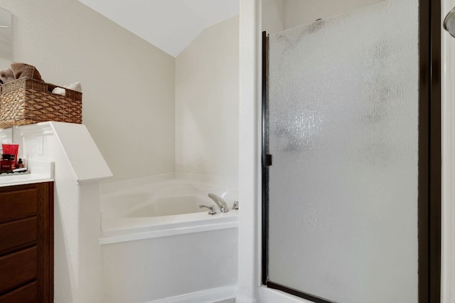 213 Sapphire Ln, Jarrell, TX 76537 - bathroom featuring a shower stall, a bath, lofted ceiling, and vanity