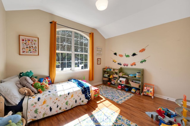 213 Sapphire Ln, Jarrell, TX 76537 - bedroom with lofted ceiling, wood finished floors, and baseboards