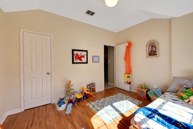 213 Sapphire Ln, Jarrell, TX 76537 - bedroom with lofted ceiling, wood finished floors, and baseboards