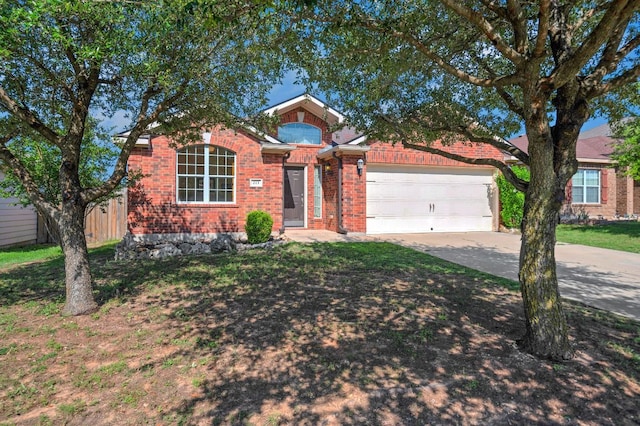 213 Sapphire Ln, Jarrell, TX 76537 - view of front of house featuring an attached garage, concrete driveway, brick siding, and a front lawn