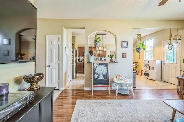 213 Sapphire Ln, Jarrell, TX 76537 - living area with light wood finished floors, ceiling fan, and arched walkways