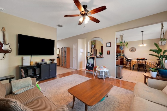 213 Sapphire Ln, Jarrell, TX 76537 - living room featuring ceiling fan, light wood-style flooring, and arched walkways