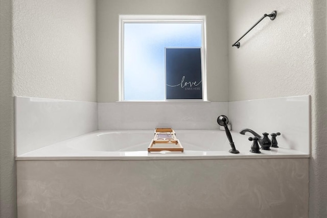 3585 W Amity Rd, Salado, TX 76571 - bathroom with a textured wall and a garden tub