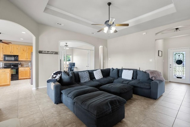 3585 W Amity Rd, Salado, TX 76571 - living area featuring ceiling fan, arched walkways, a raised ceiling, light tile patterned floors, and recessed lighting