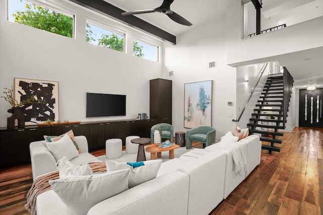 living room featuring high vaulted ceiling, a ceiling fan, stairs, and wood-type flooring