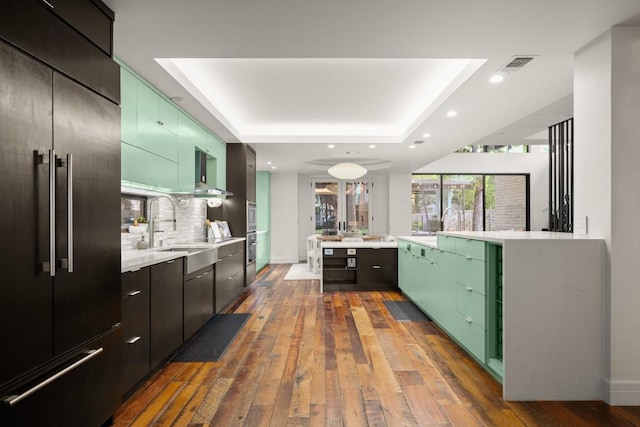 1705 Collier St, Austin, TX 78704 - kitchen with built in fridge, a raised ceiling, dark wood-type flooring, light countertops, and recessed lighting