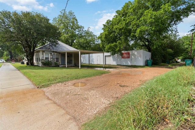 300 Bishop St, Smithville, TX 78957 - view of grassy yard featuring a carport and driveway