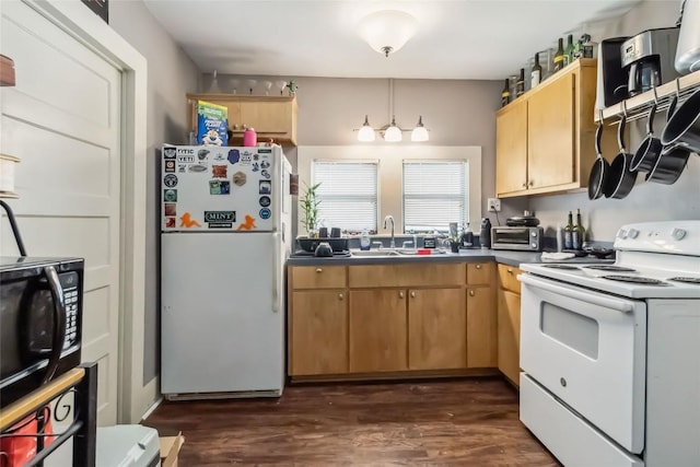 300 Bishop St, Smithville, TX 78957 - kitchen with white appliances, a sink, dark countertops, and dark wood-type flooring