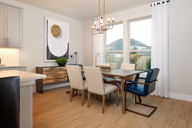 dining space with light wood-style flooring, plenty of natural light, and a chandelier