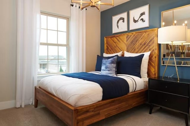 carpeted bedroom with a chandelier