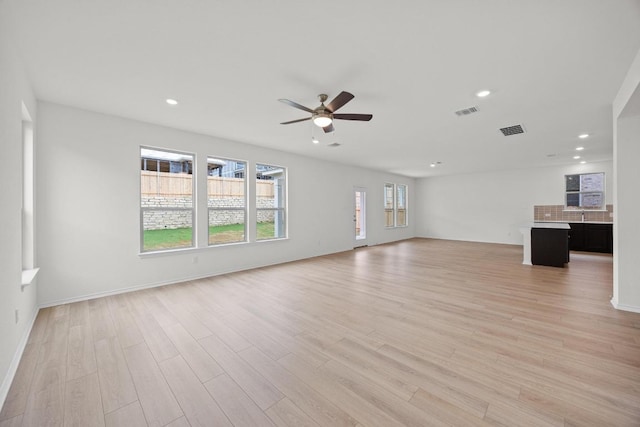 3740 Liberi Ln, Round Rock, TX 78655 - unfurnished living room featuring ceiling fan, light wood-style floors, and recessed lighting