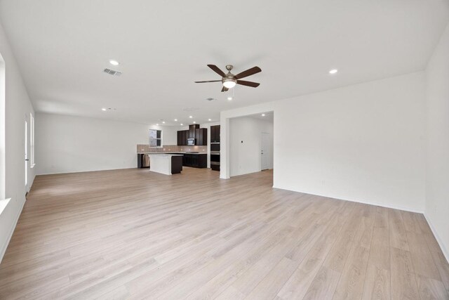3740 Liberi Ln, Round Rock, TX 78655 - unfurnished living room with a ceiling fan, recessed lighting, and light wood-type flooring