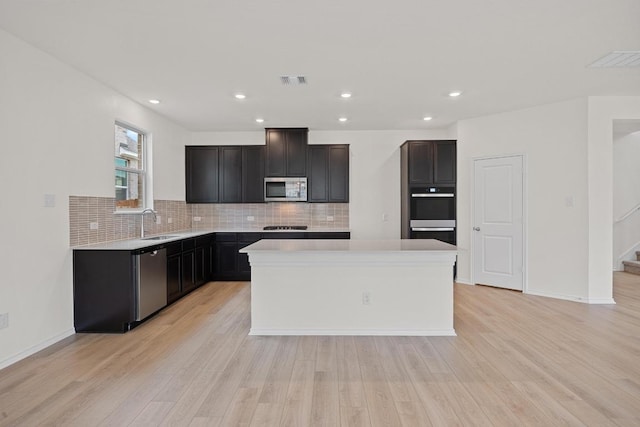 3740 Liberi Ln, Round Rock, TX 78655 - kitchen with appliances with stainless steel finishes, backsplash, light countertops, light wood-type flooring, and recessed lighting