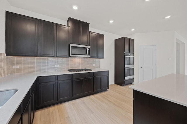 3740 Liberi Ln, Round Rock, TX 78655 - kitchen featuring stainless steel appliances, light wood-style flooring, decorative backsplash, light countertops, and recessed lighting