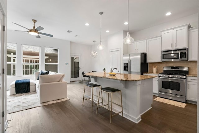 4108 Berkman Dr, Austin, TX 78723 - kitchen with appliances with stainless steel finishes, ceiling fan, light stone counters, tasteful backsplash, and recessed lighting