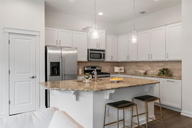 4108 Berkman Dr, Austin, TX 78723 - kitchen featuring stainless steel appliances, a sink, decorative backsplash, white cabinets, and recessed lighting