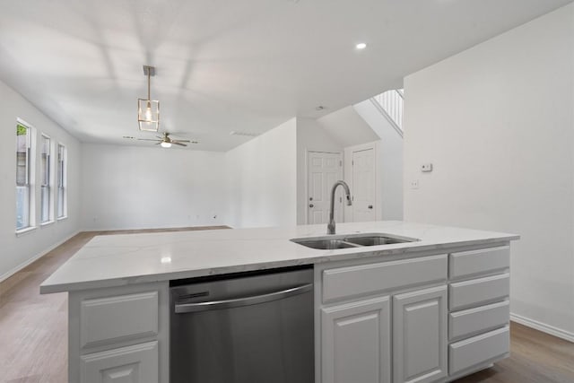 1816 Melissa Oaks Ln, Austin, TX 78744 - kitchen with stainless steel dishwasher, a sink, open floor plan, wood finished floors, and recessed lighting