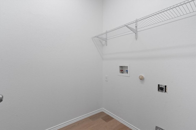 1816 Melissa Oaks Ln, Austin, TX 78744 - laundry room with wood finished floors, hookup for a washing machine, baseboards, hookup for an electric dryer, and hookup for a gas dryer