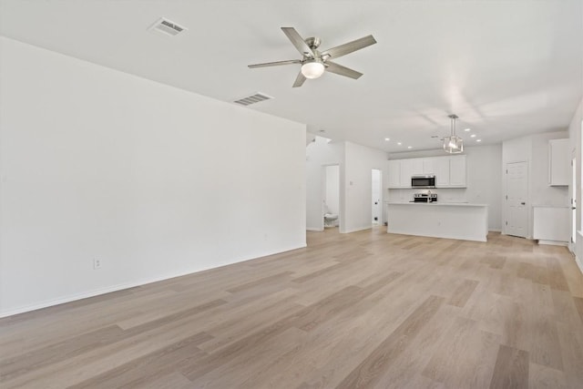 1816 Melissa Oaks Ln, Austin, TX 78744 - unfurnished living room with light wood-type flooring, a ceiling fan, recessed lighting, and baseboards
