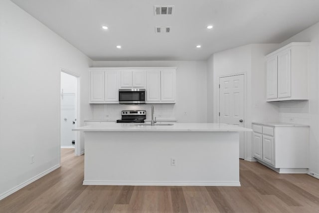 1816 Melissa Oaks Ln, Austin, TX 78744 - kitchen with stainless steel appliances, a sink, decorative backsplash, light wood-type flooring, and recessed lighting