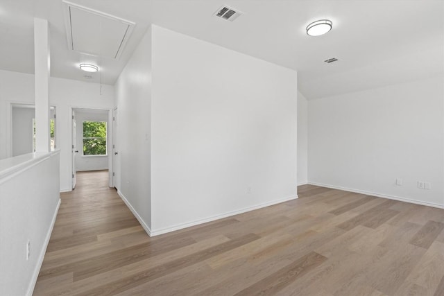 1816 Melissa Oaks Ln, Austin, TX 78744 - empty room with attic access, wood finished floors, and baseboards